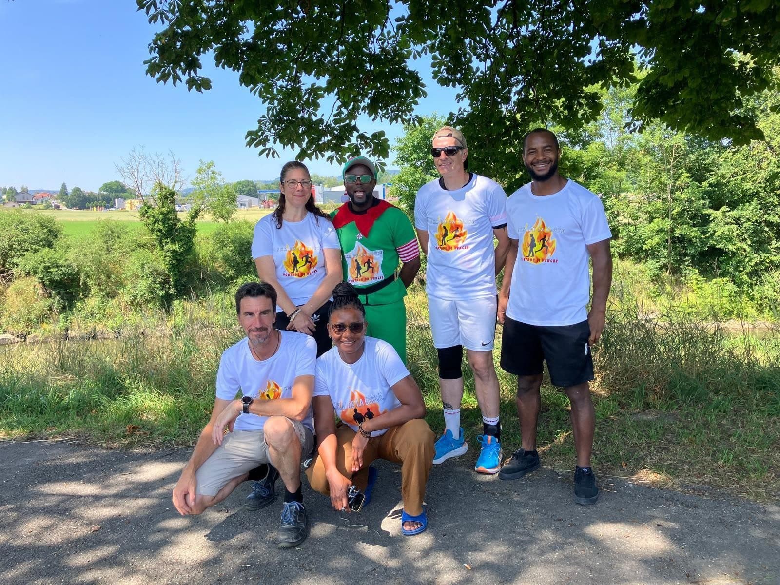 Bénévoles du 5 km de la Broye et Vontade de Vencer réunis au bord de la Broye, en t-shirts de l’événement.